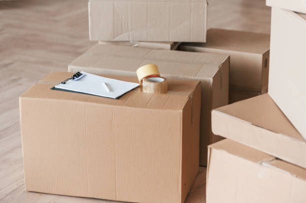 istock Boxes with scotch tape and notepad. Conception of moving to new house 1834690396
