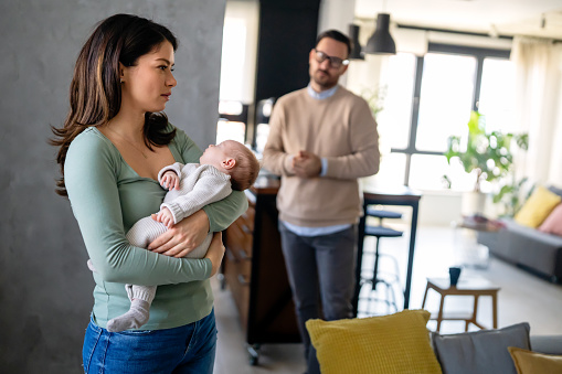 Young woman suffering from postnatal depression at home