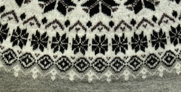 istock Black and white Winter Knitted Sweater Pattern Design with snowflakes. Handmade knitting wool fabric texture. Background of kniting patterns and ornament. 1834709774