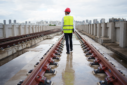 Railway workers inspecting train tracks