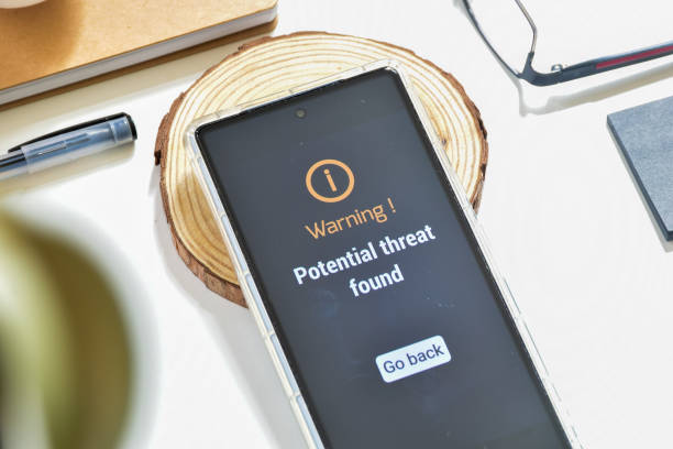 istock Smartphone with notification potential threat found on desk. Virus and threat protection concept 1834733406