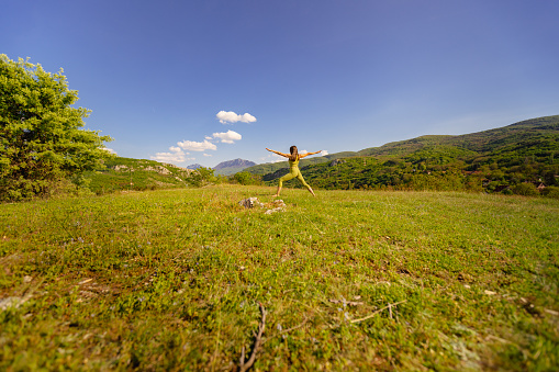 The beauty of outdoor yoga: a yoga teacher immersed in a session, surrounded by the calming embrace of nature.