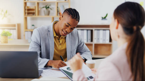 istock Startup, consultants and black man in office, conversation and new project, schedule and share ideas. Employees, female client and male worker explain process, system and planning with paperwork 1834738974