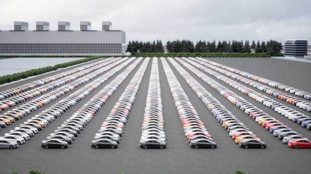 Wolfsburg, Germany – September 30, 2024: View of the production plant of the Volkswagen headquarter in Wolfsburg with dock and canal in the foreground and large Volkswagen logo on the factory