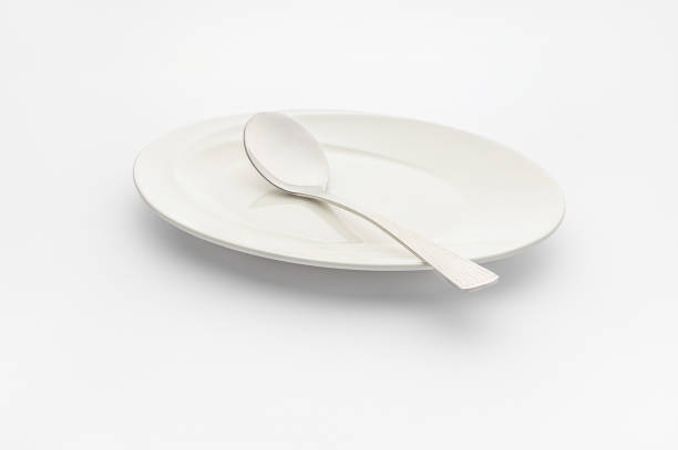 istock Plate and spoon on a white background, high-key photography. 1834762505