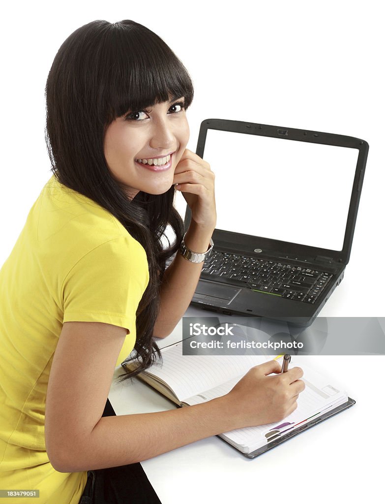 female student with a laptop and notebooks Happy female student with a laptop and notebooks . isolated over white Adult Stock Photo