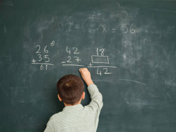 istock Cute honored child at front of chalkboard. 1834819248