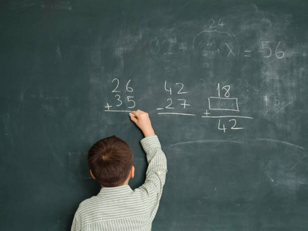 istock Cute honored child at front of chalkboard. 1834819249