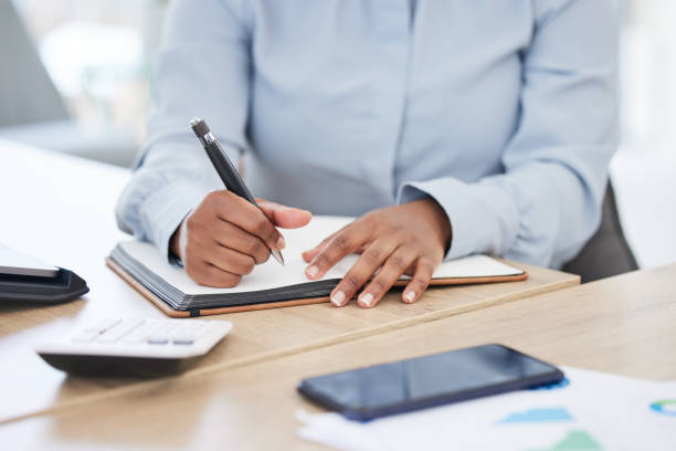 istock Business hands, writing and planning budget, finance and data analytics notes, ideas or brainstorming with calculator. Professional accountant, analyst or person with notebook for profit or revenue 1834820313
