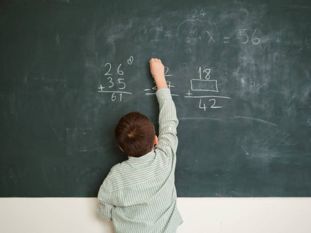 istock Cute honored child at front of chalkboard. 1834821538