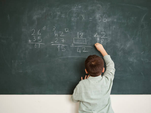 istock Cute honored child at front of chalkboard. 1834821882