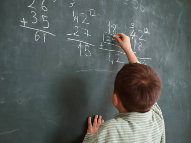istock Cute honored child at front of chalkboard. 1834823440