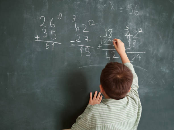 istock Cute honored child at front of chalkboard. 1834823441