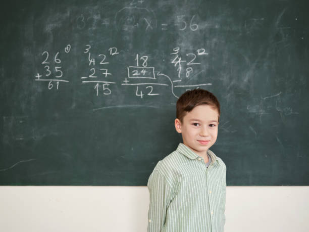 istock Cute honored child at front of chalkboard. 1834825532