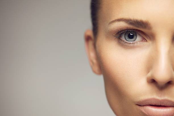 istock Young woman half face closeup 183483009