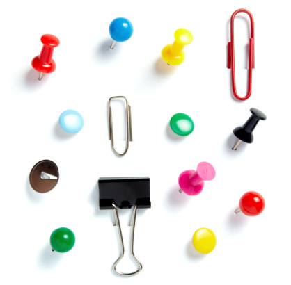 close up of various pushpins  on white background