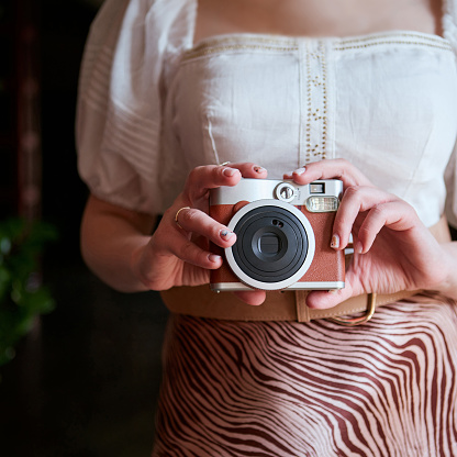 Close view of a girl holding a retro camera