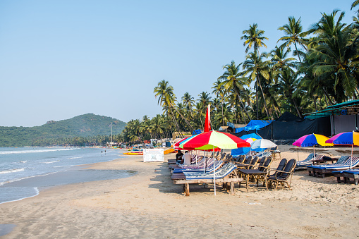 Tropical landscape with beach with coconut trees at sunset.