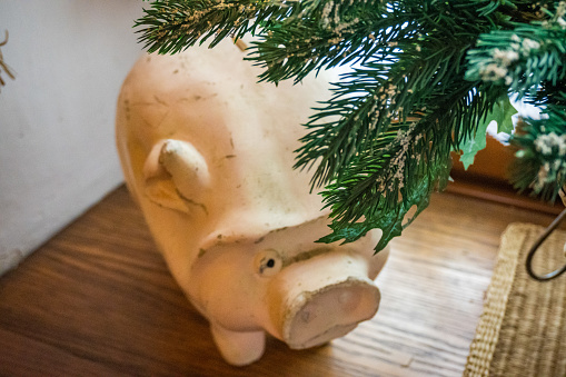 Piggy bank and Christmas ornament over white background.