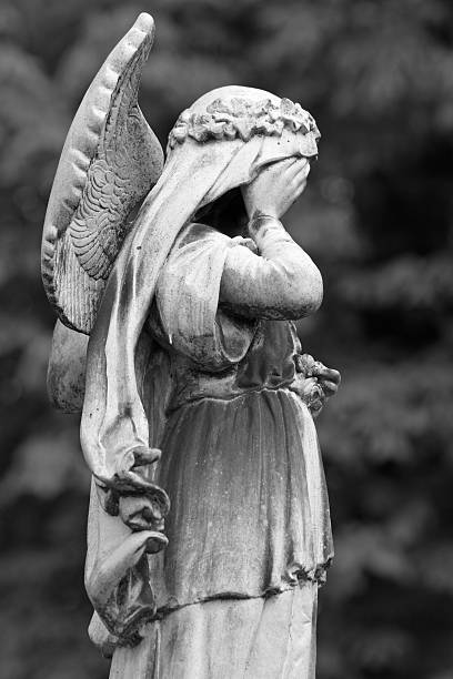 istock statue of crying cemetery angel 183487426