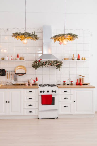 istock Interior of a light white kitchen with bright red decor elements in the Scandinavian style, decorated for Christmas 1834877383
