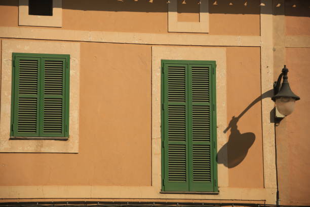 istock mediterranean house facade with a lantern and green window shutters 1834886586