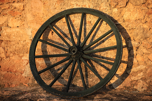 Weathered old wagon wheel on a freight wagon.