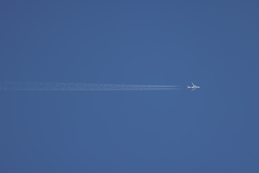 jet contrail, blue sky background