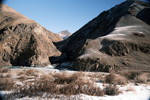 Frozen stream in winter mountains