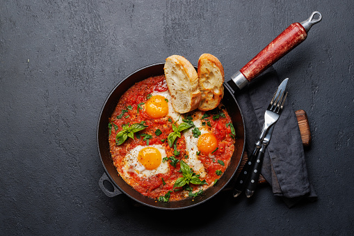 Delicious shakshuka breakfast in a pan. Flat lay with copy space