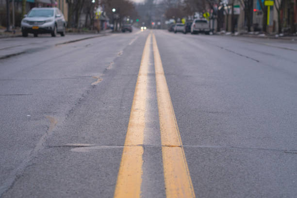 istock wet road morning light looking at the dividing line 1834997208
