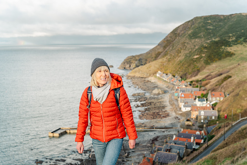 Senior woman at the coastal village of Crovie on the Aberdeenshire coast of Scotland. The local pronunciation is Crivey.