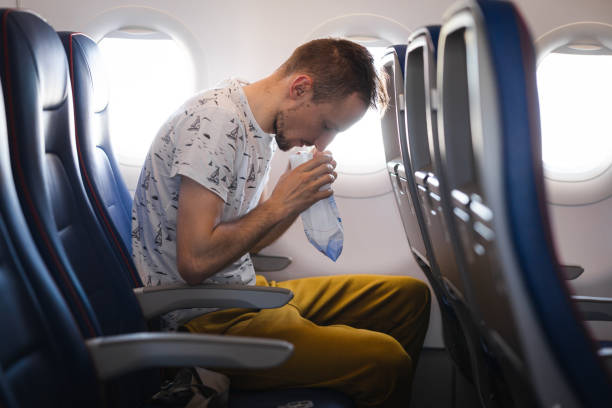 istock Young tourist feeling ill on the airplane while travelling 1835006846