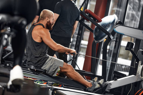 istock Training legs in the simulator, the athlete works with his legs on the simulator, working out the muscles on the legs 1835007378