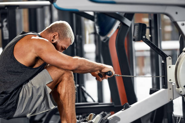 istock Training legs in the simulator, the athlete works with his legs on the simulator, working out the muscles on the legs 1835007914