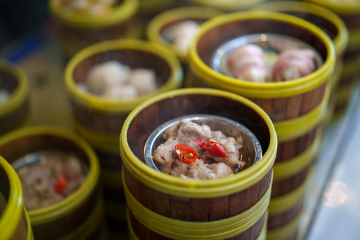 A tempting array of Chinese dim sum, meticulously arranged in bamboo steamers, offering a delectable assortment of flavors and textures