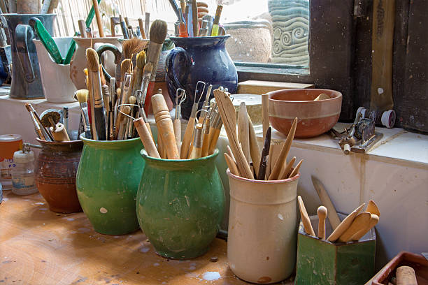 istock detail from pottery work room - brushes and tools 183501628