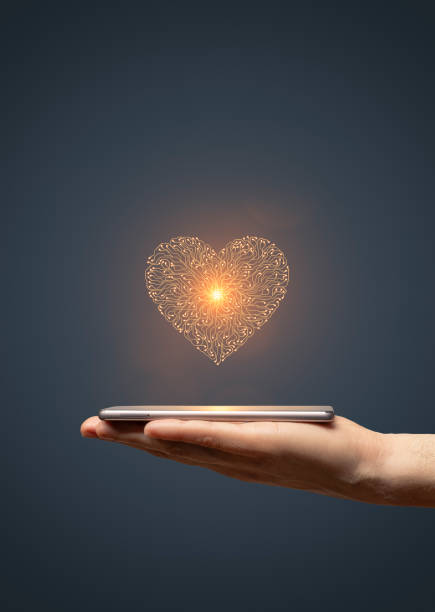 istock Circuit board heart symbol on hand holding smartphone 1835023913