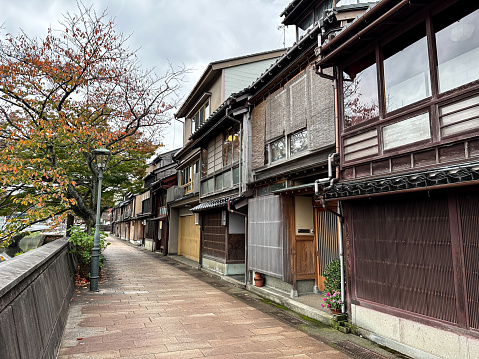 Kanazawa, Japan - 06.11.2023. Street view and facades of medieval wooden houses in Kazuemachi Chaya District in Kanazawa, Ishikawa Prefecture, Japan. Autumn in Japan. Geisha and teahouse district