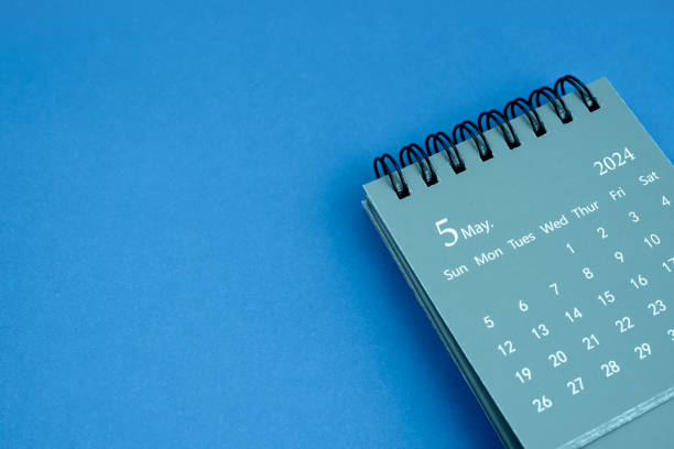 istock May 2024 desk calendar on blue color background. 1835044629