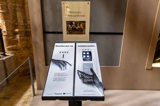 Segovia, Spain, 03.10.21. Donation payment terminal in the Segovia Cathedral allowing believers to donate without cash, modern donation service.