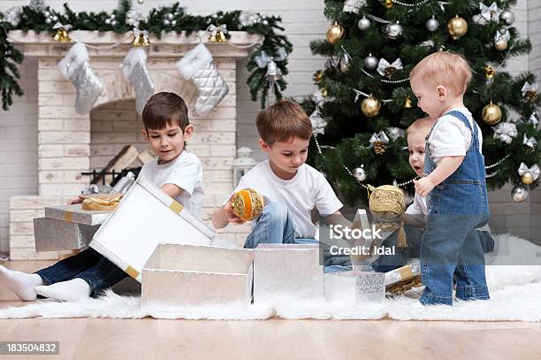 Children Under The Christmas Tree With Gifts And Toys Stock Photo - Download Image Now