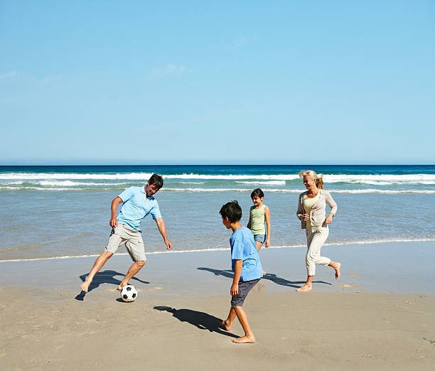 istock Family playing soccer on the beach 183506000