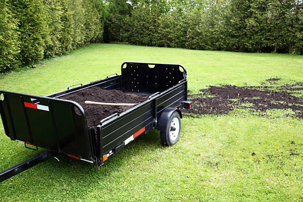 Topdressing Lawn Topdressing grass with soil to improve growth. trailer stock pictures, royalty-free photos & images