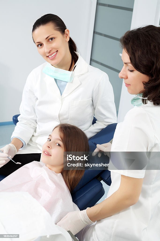 Girl visiting a dentist. Little pretty girl in dentist office. Looking at camera. Above Stock Photo