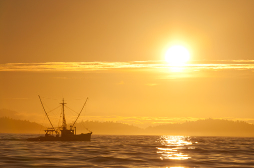 An Alaskan fishing boat at sunrise.