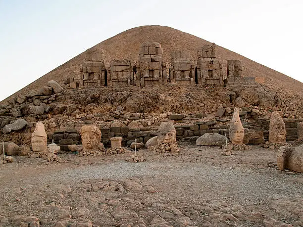 "Enigmatic huge stone sculptures at the top of the archaeological site of Nemrut Dagi. Nemrut Dagi is a 2134m high mountain in southeastern Turkey, where a number of large statues is erected around what is assumed to be a royal tomb from the first century BCE."