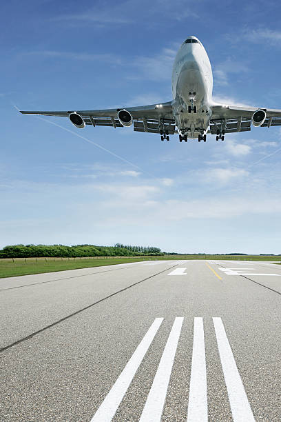 istock jumbo jet airplane landing on runway 183507102