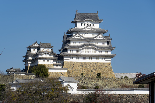 Himeji, Japan - March 26, 2019: Himeji Castle during spring cherry blossom season. The castle dates from 1333 and is considered one of the finest surviving example of Japanese castle architecture.