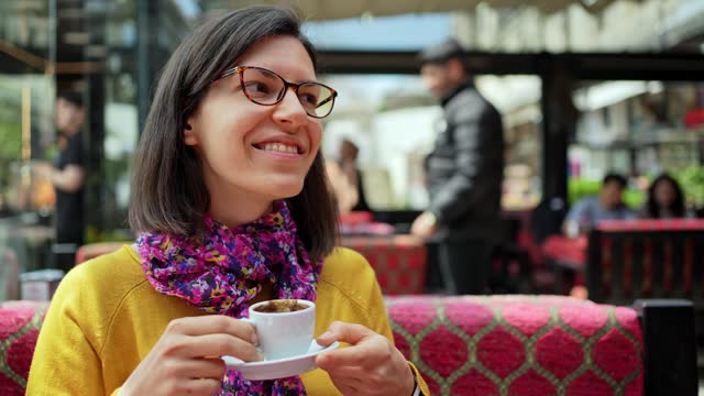 Young Woman Drinking Coffee In A Sidewalk Café In Istanbul